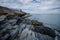 Rhode Island Cliff Walk shows breaking waves along the rocky shoreline of the Atlantic Ocean