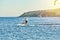 Rhodes, Greece - July 08 2017: Men goes kitesurfing on azure sea water against clear sky