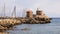 Rhodes, windmills and fort of Saint Nicholas in Mandraki harbour. Rhodes, Greece