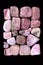 Rhodochrosite heap stones filled texture on black background