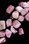 Rhodochrosite heap up stones texture on black background