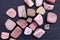 Rhodochrosite heap up stones texture on black stone background