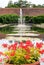 RHS Wisley Water fountain with Vibrant Red Geraniums in the foreground