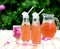 Rhubarb hibiscus iced tea with rose petals in the garden