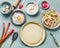 Rhubarb pie preparation. Tart baking pan with dough on kitchen table background with rolling pin, flour, egg and fresh red rhubarb