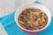 Rhubarb stewed in a mixing bowl on a blue placemat