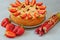 Rhubarb strawberry pie on the gray kitchen background. Veggie berries tart decorated with organic fresh strawberries