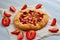 Rhubarb tart with strawberry on the gray concrete background. Vegetarian healthy rhubarb galette decorated with fresh strawberries