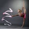 Rhythmic gymnast doing vertical split with ribbon