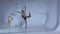 Rhythmic gymnast gracefully dancing with a ribbon in his hands. White background. Slow motion