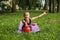 Rhythmic gymnastics. Preteen child gymnast performs an exercise with ball on sport mat