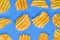 Ribbed potatoes snack with pepper on blue background. Ridged potato chips on blue background. Collection. Flat lay