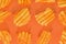 Ribbed potatoes snack with pepper on pastel orange background. Ridged potato chips on orange background. Collection