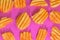 Ribbed potatoes snack with pepper on pink background. Ridged potato chips on pink background. Set of potato chips. Flat