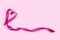 Ribbon detail as a heart sign on pink background.