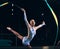 Ribbon gymnastics, woman and happy portrait of dancer in performance, sports competition and dark arena. Female athlete