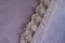 Ribbon of lace sewn to mauve fabric