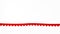 A ribbon made of small red hearts on a white background.