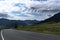 ribbon of the road among the slopes of the mountains on the expanses of Altai on a summer day