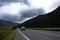 ribbon of the road among the slopes of the mountains on the expanses of Altai on a summer day