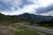 ribbon of the road among the slopes of the mountains on the expanses of Altai on a summer day