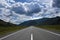 ribbon of the road among the slopes of the mountains on the expanses of Altai on a summer day