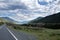 ribbon of the road among the slopes of the mountains on the expanses of Altai on a summer day