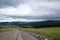 ribbon of the road among the slopes of the mountains on the expanses of Altai on a summer day