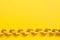 Ribbon shiny yellow serpentine on a yellow background