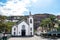 Ribeira Brava, Madeira, Portugal - Sep 9, 2019: Beautiful Roman Catholic Church in the city center. Palm trees on the square.