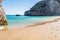 Ribeiro do Cavalo Beach with clear turquoise water with rocks and a ball floating in the water, Sesimbra PORTUGAL