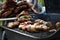 Ribs and bacon wrapped jalapenos on the grill at a backyard cookout