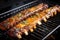 ribs under a broiler showing caramelizing sauce