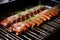 ribs under a broiler showing caramelizing sauce