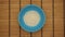 Rice in a blue dish on a wooden background - Stop motion