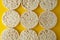 Rice cakes background, over yellow background. Top view. Food background. Dietary rice bread