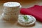 Rice cakes, one with cream cheese and herbs on wood, red napkin