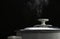 Rice cooking steam on black background hot meal kitchenwear in A