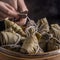 Rice dumpling, zongzi - Bunch of Chinese traditional cooked food on wooden table over black background, concept of Dragon Boat