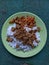 Rice with fried tempeh and chili served in a green plate