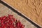 Rice grains and red chili peppers drying on the ground after harvest