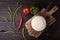 Rice in iron stewpan with green beans and other vegetables on wooden cutting plank. View from above