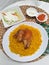 Rice Mandi with chicken, salad and sambal as condiment. a delicious Arabic Cuisine