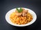 Rice with meat and vegetables on a plate. Pilaf isolated o