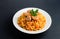 Rice with meat on a white plate. Pilaf on gray background