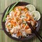 Rice noodles with chicken, shrimp and vegetables closeup