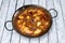 Rice paella with lobster and clams mounted in a Valencian paella pan