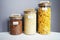 Rice, pasta and buckwheat in transparent containers on a white table