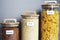 Rice, pasta and buckwheat in transparent containers on a white table