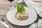 Rice pilau with meat and carrot and glass of red wine on wooden table